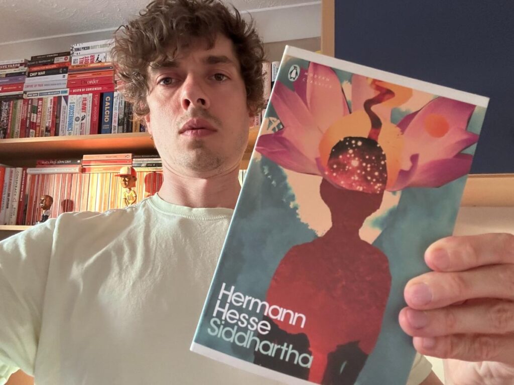 Tom holding his copy of Siddharttha